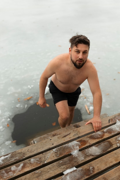 Full shot man experiencing cold exposure for wellness