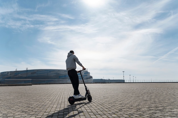 Free Photo full shot man having fun with electric scooter