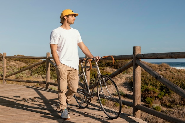 Full shot man holding bicycle