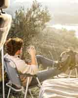 Free photo full shot man holding cup outdoors