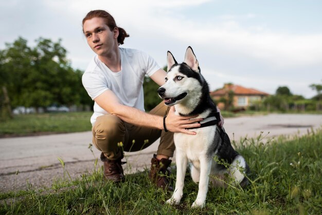 Full shot man holding husky