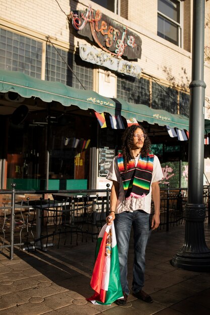 Full shot man holding mexican flag