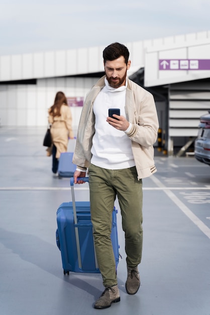 Full shot man holding smartphone