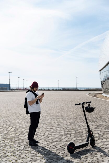 Full shot man holding smartphone