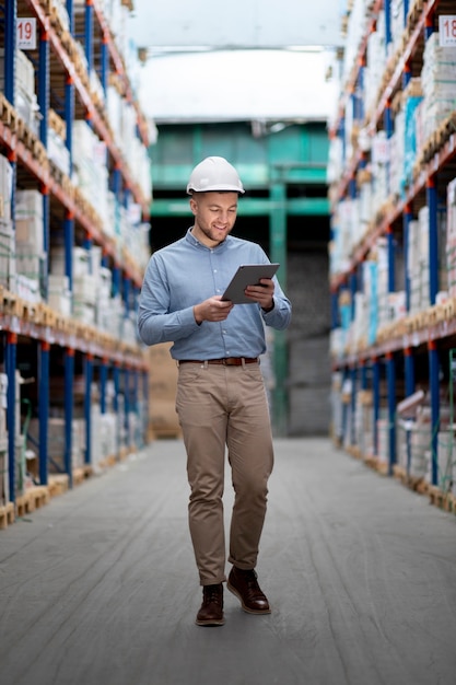 Full shot man holding tablet