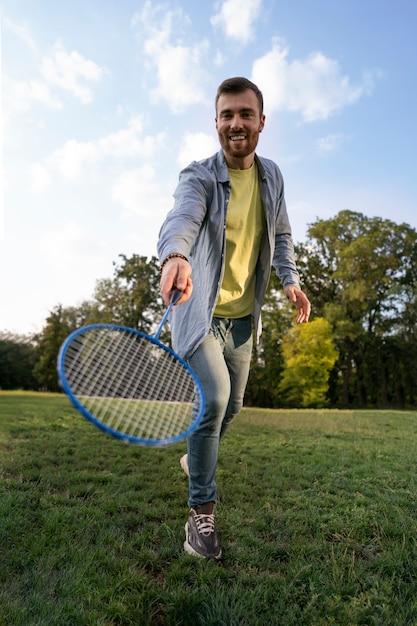 Full shot man holding tennis racket