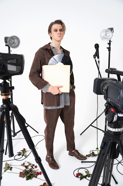 Full shot man holding vinyl record