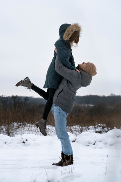 Full shot man holding woman up