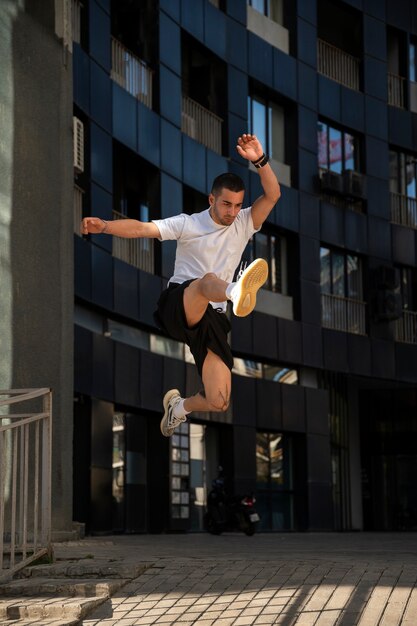 Full shot man jumping outdoors