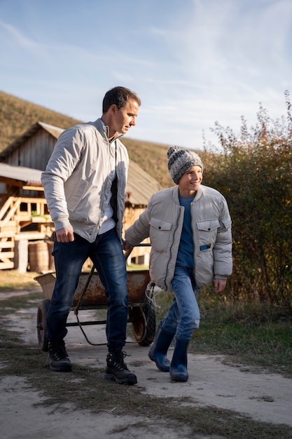 Full shot man and kid walking together