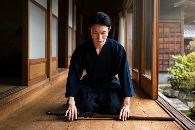 Free photo full shot man meditating indoors