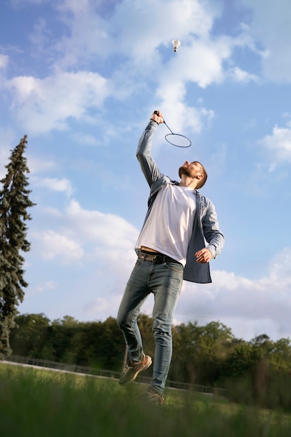 Free photo full shot man playing badminton