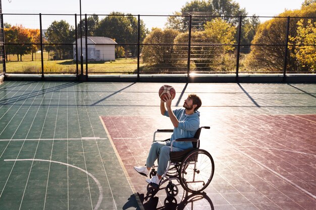 Full shot man playing basketball outdoors