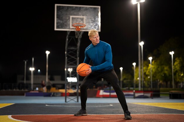 Full shot man playing basketball