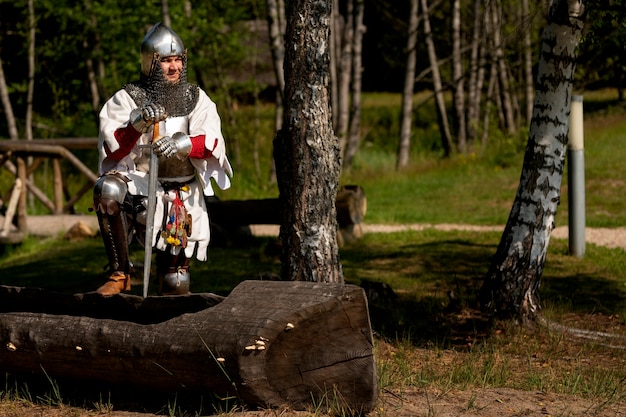 Full shot man posing as a medieval soldier