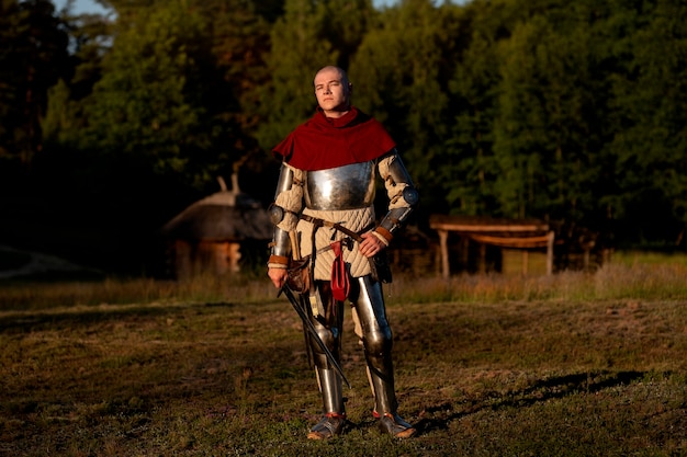 Full shot man posing as a medieval soldier