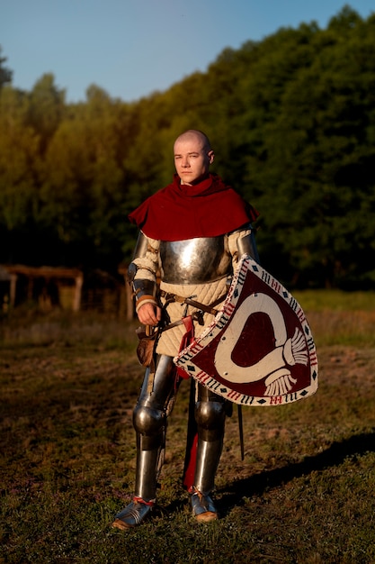 Full shot man posing as a medieval soldier