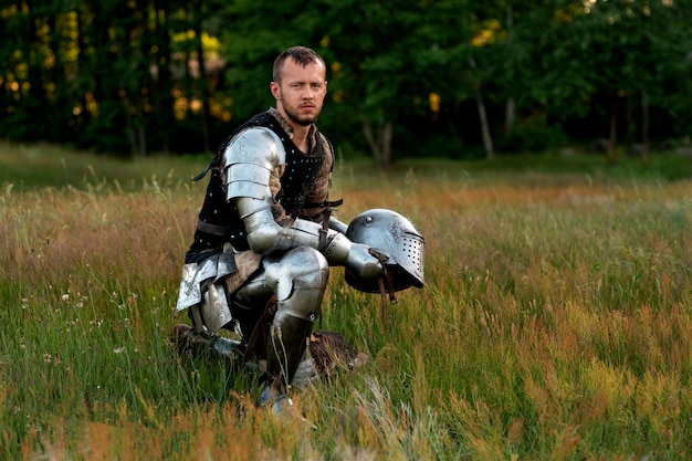 Full shot man posing as a medieval soldier