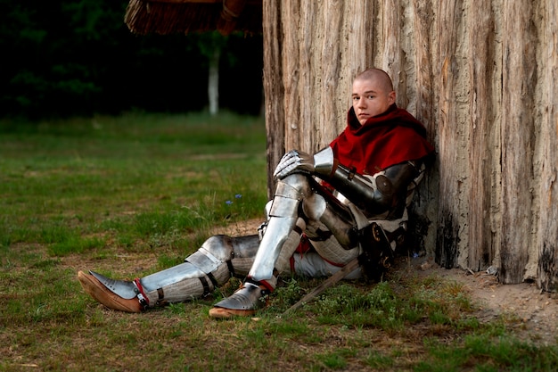 Full shot man posing as a medieval soldier