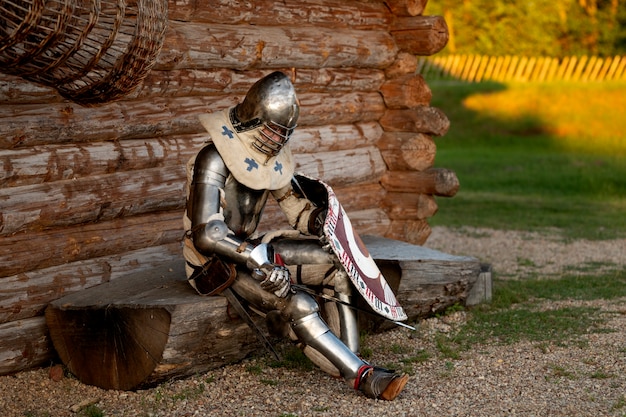 Full shot man posing as a medieval soldier