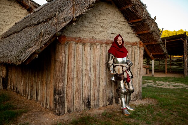 Full shot man posing as a medieval soldier