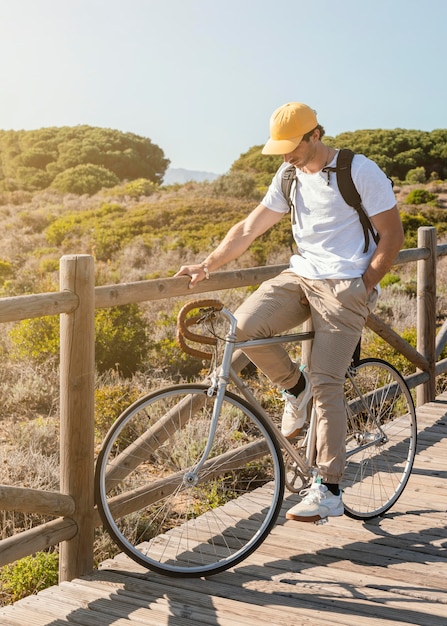 Free photo full shot man posing on bicycle