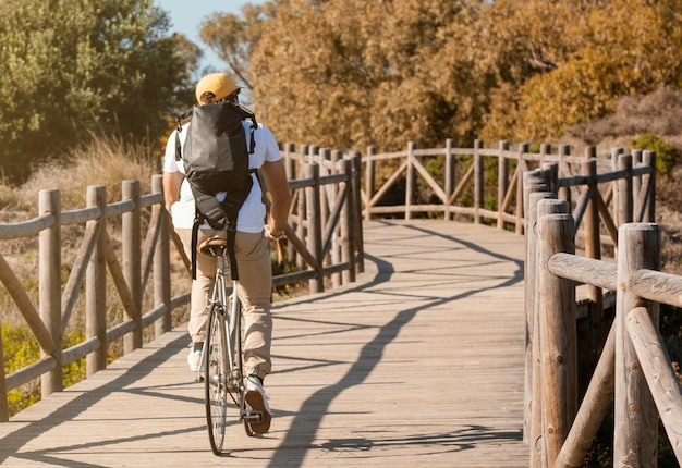 Full shot man riding bicycle