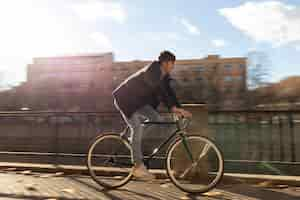 Free photo full shot man riding bicycle