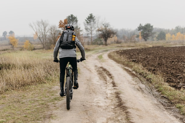 Full shot of man riding a bike