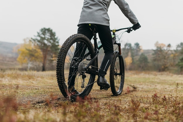 Free photo full shot of man riding a bike