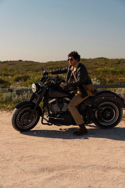 Free photo full shot man riding a motorbike