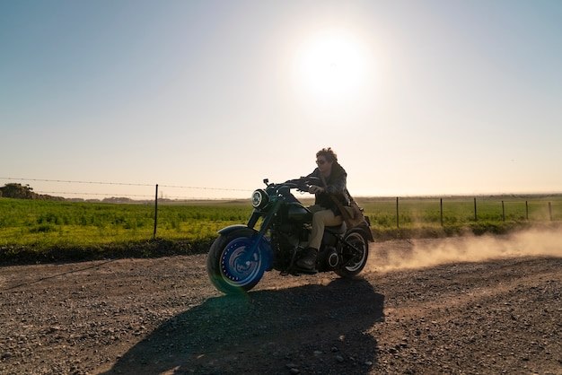 Free photo full shot man riding a motorbike