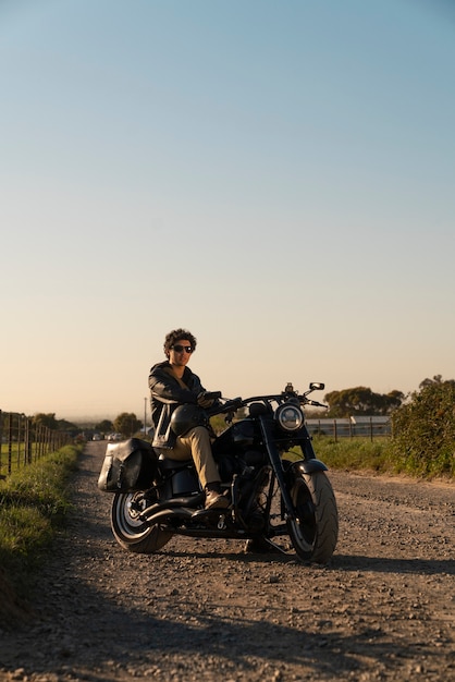 Free photo full shot man riding a motorbike