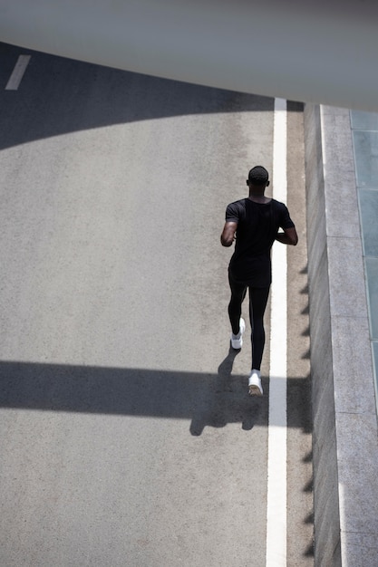 Full shot man running on street