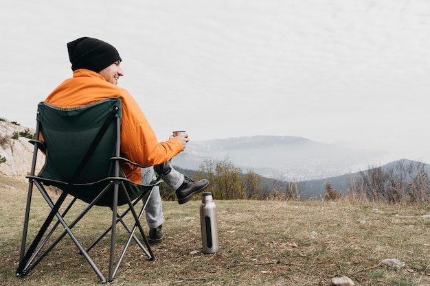 Free photo full shot man sitting on chair