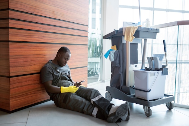 Full shot man sitting on floor