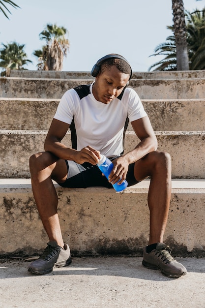 Full shot man sitting on stairs