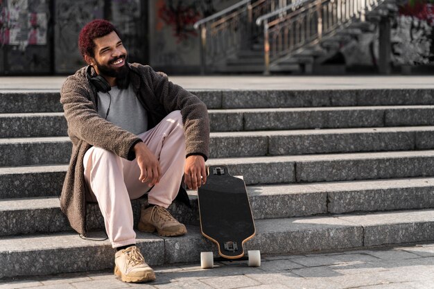 Full shot man sitting on stairs