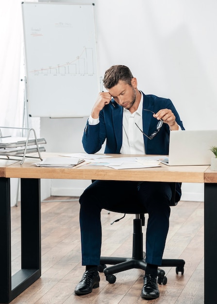 Full shot man sitting at table