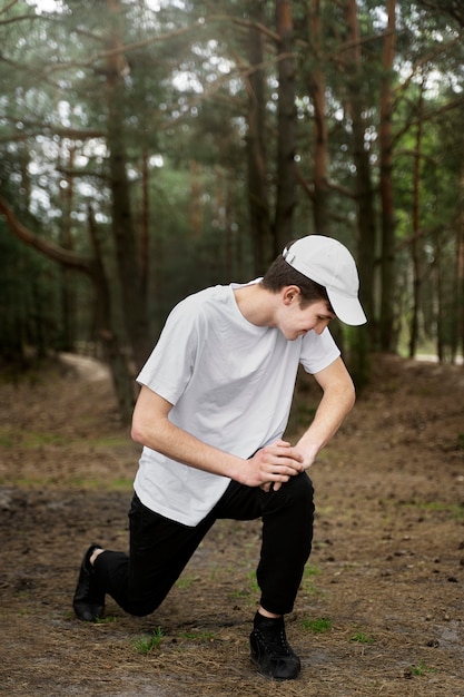 Full shot man stretching outdoors