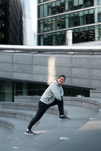 Full shot man stretching on stairs