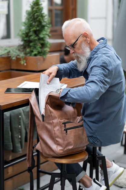 Free Photo full shot man studying outdoors