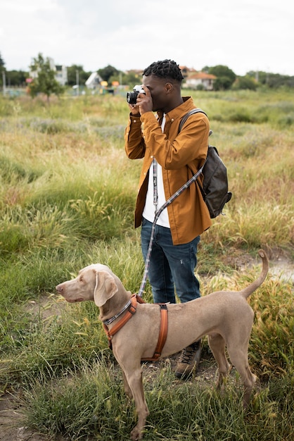 Free photo full shot man taking photos in nature