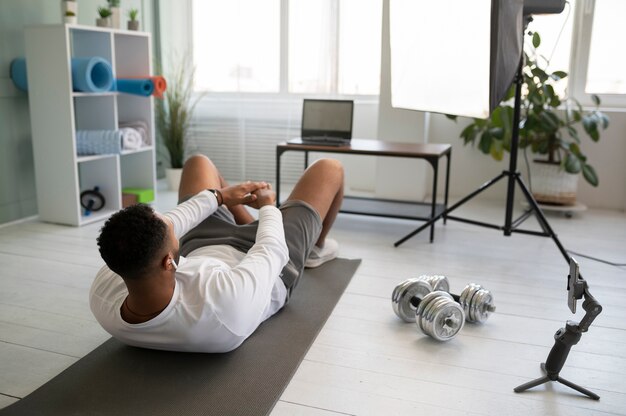 Full shot man training on yoga mat