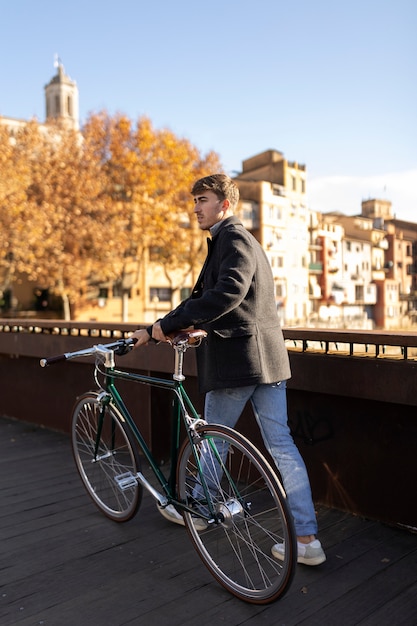 Full shot man walking with bicycle