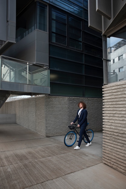 Full shot man walking with bicycle