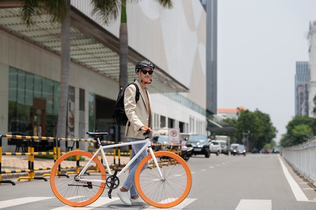 Full shot man walking with bicycle