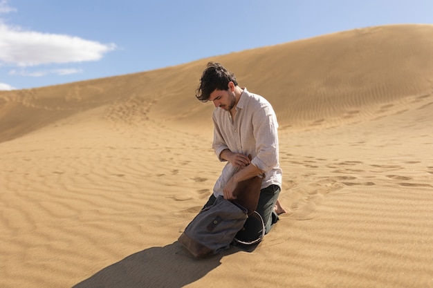 Full shot man with backpack in desert