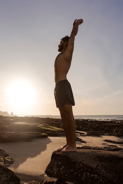 Free Photo full shot man with hairy chest at seaside