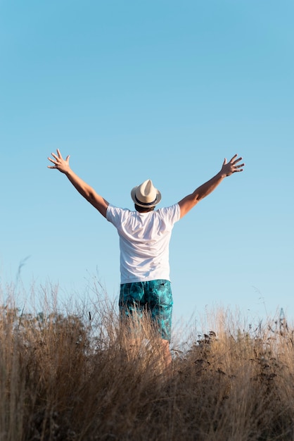 Full shot of a man with his arms in the air